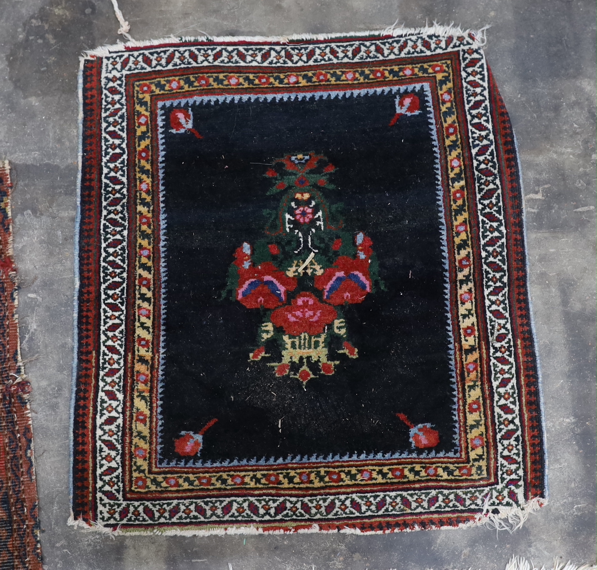An antique Tekke red ground rug, a Caucasian rug and three others, largest 194 x 138cm